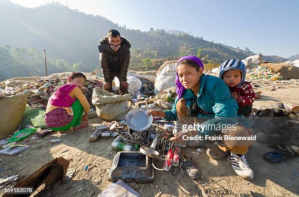 Family with a small child sorting out garbage at Aletar garbage dump. The garbage collected off the streets of the capital city is mostly sorted for...