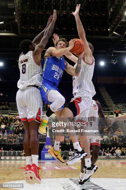 Nathan Sobey of the Bullets drives to the basket under pressure from Gary Clark of the Hawks during the 2023 NBL Blitz match between Brisbane Bullets...