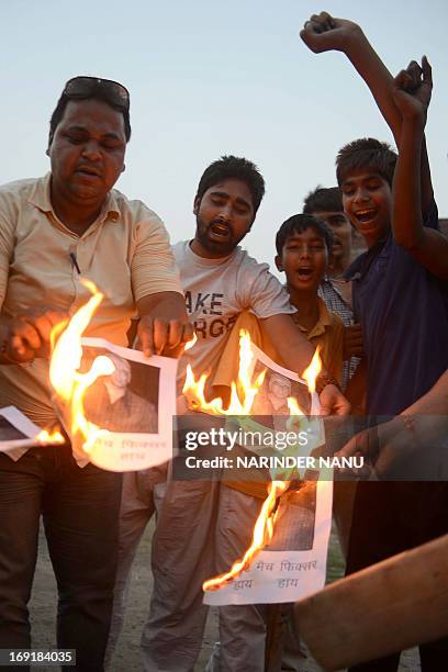 Indian activists of Youth Bhagwan Valmiki Mahasangh Punjab burn photogarphs of Indian actor Vindu Dara Singh during a demonstration in Amritsar on...