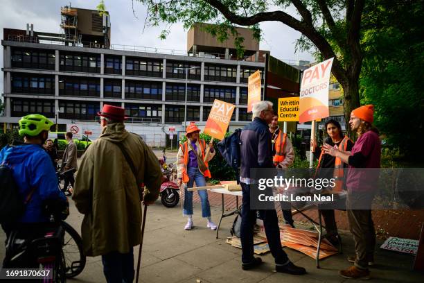 Group of junior doctors hold placards and hand out leaflets as they picket outside the Whittington Hospital on September 20, 2023 in London, England....