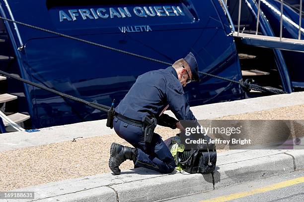 Police evacuate the area beside the Palais de Festival due to an unattended bag being left on the ground on May 20, 2013 in Cannes, France. There is...