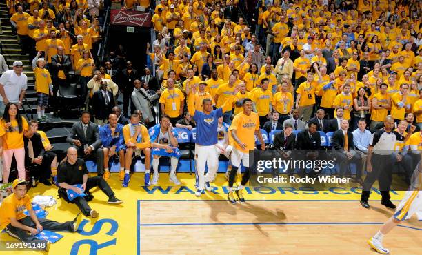 Scott Machado and Kent Bazemore of the Golden State Warriors cheer on their teammates against the San Antonio Spurs in Game Six of the Western...