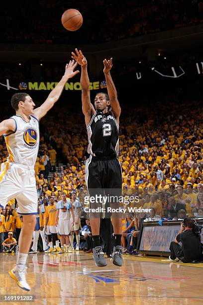 Kawhi Leonard of the San Antonio Spurs shoots a three pointer against Klay Thompson of the Golden State Warriors in Game Six of the Western...