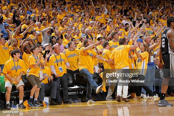 Fans cheer in celebration for the Golden State Warriors as they face the San Antonio Spurs in Game Six of the Western Conference Semifinals during...