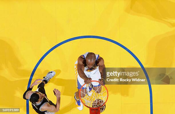 Carl Landry of the Golden State Warriors dunks against Danny Green of the San Antonio Spurs in Game Six of the Western Conference Semifinals during...