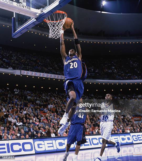Larry Hughes of the Washington Wizards takes the ball up for the dunk during the game against the Orlando Magic at TD Waterhouse Centre on December...
