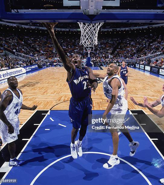 Michael Jordan of the Washington Wizards takes the shot over Grant Hill of the Orlando Magic during the game at TD Waterhouse Centre on December 6,...