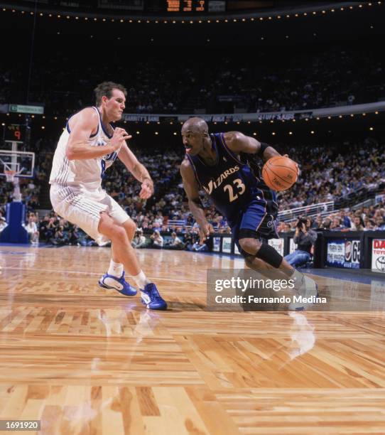 Michael Jordan of the Washington Wizards tries driving around Pat Burke of the Orlando Magic during the game at TD Waterhouse Centre on December 6,...