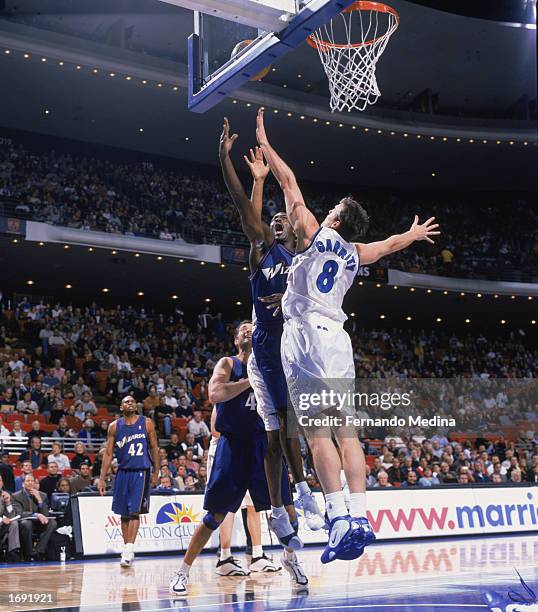 Michael Jordan of the Washington Wizards under pressure from Pat Garrity of the Orlando Magic goes up for the shot during the game at TD Waterhouse...
