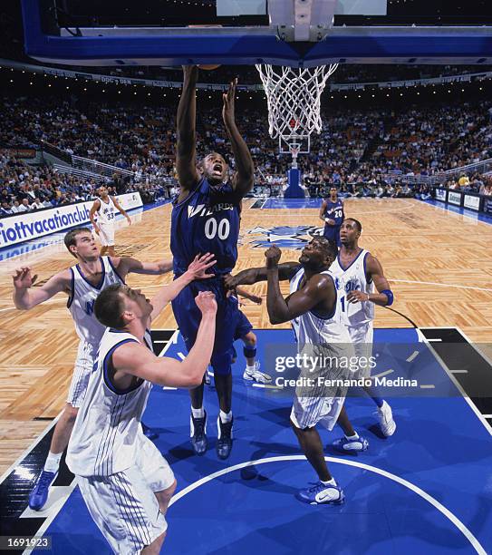 Brendan Haywood of the Washington Wizards takes the shot over Mike Miller and Shawn Kemp of the Orlando Magic during the game at TD Waterhouse Centre...