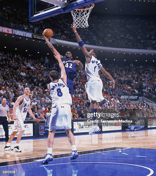 Jerry Stackhouse of the Washington Wizards covered by Tracy McGrady and Pat Garrity of the Orlando Magic takes the shot during the game at TD...