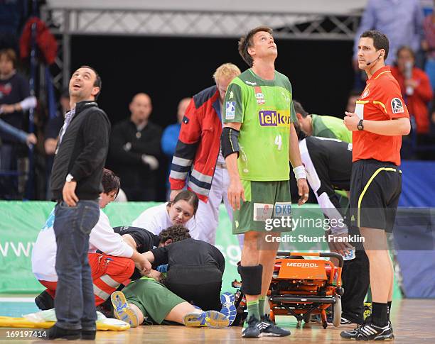 Ivan Nincevic of Berlin receives treatment for a serious injury during the DKB Bundeliga match between HSV Hamburg and Fuechse Berlin at O2 World on...