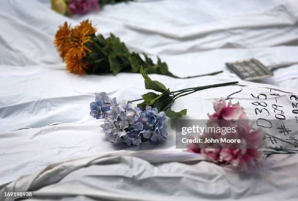 The remains of unidentified immigrants lie in a cemetery after being exhumed on May 21, 2013 in Falfurrias, Texas. Teams from Baylor University and...