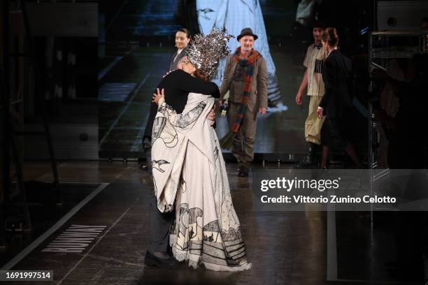 Fashion designer Antonio Marras and Marisa Berenson acknowledge the applause of the audience at the Antonio Marras fashion show during the Milan...