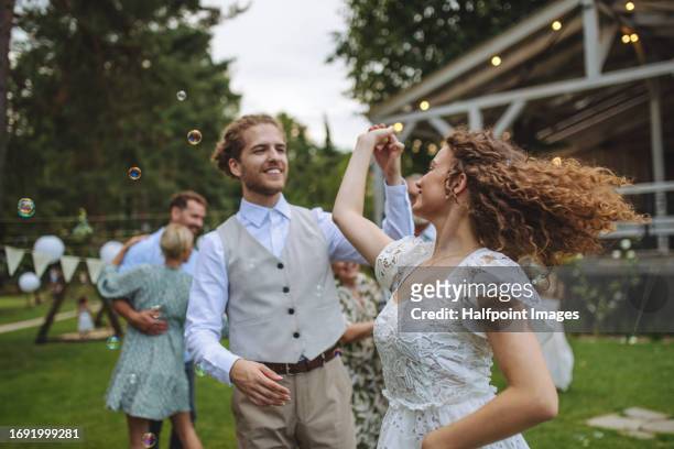 bride and groom dancing at small garden wedding. - small wedding stock pictures, royalty-free photos & images