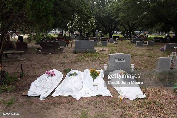 The remains of unidentified immigrants lie in a cemetery after being exhumed on May 21, 2013 in Falfurrias, Texas. Teams from Baylor University and...