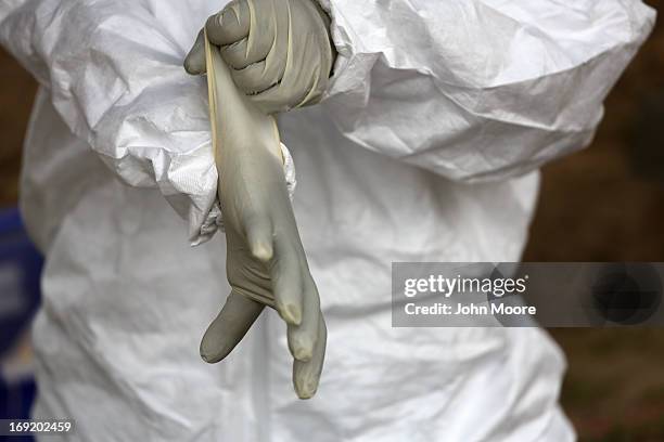 Forensic anthropology team member from Baylor University prepares to exhume the remains of immigrants at a cemetery on May 21, 2013 in Falfurrias,...