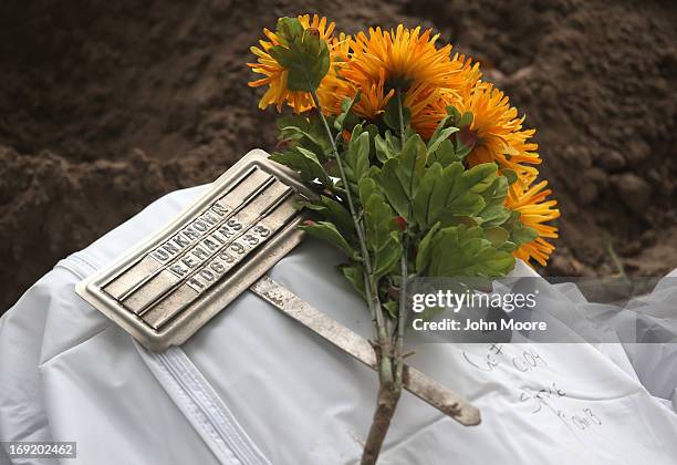 The remains of unidentified immigrants lie in a cemetery after being exhumed on May 21, 2013 in Falfurrias, Texas. Teams from Baylor University and...