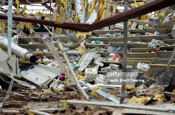 Items remain on the collapsed shelves of a Dollar General store destroyed by yesterday's tornado on May 21, 2013 in Moore, Oklahoma. The town...