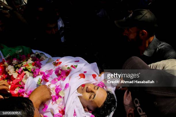 Relatives and friends mourn the body of the Palestinian man, Yousef Radwan, 25 years old, on September 20 in the city of Khan Yunis, south of the...