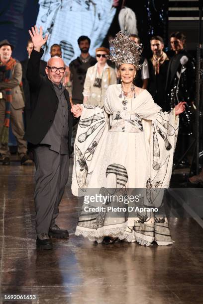 Fashion designer Antonio Marras and Marisa Berenson acknowledge the applause of the audience at the Antonio Marras fashion show during the Milan...