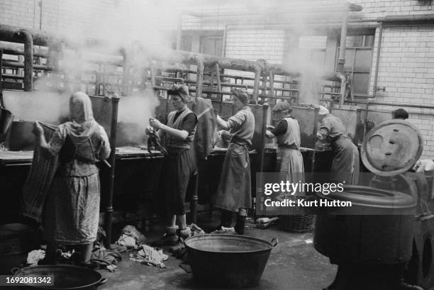 Women cleaning clothes at a public wash house in Newcastle, 1955. Original Publication: Picture Post - 7801 - Newcastle Wash House - unpub. 1955.