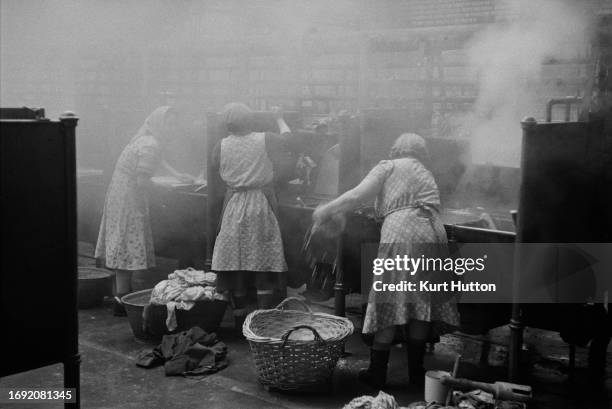 Women cleaning clothes at a public wash house in Newcastle, 1955. Original Publication: Picture Post - 7801 - Newcastle Wash House - unpub. 1955.