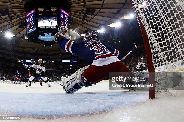 Henrik Lundqvist of the New York Rangers makes a glove save against the Boston Bruins in Game Three of the Eastern Conference Semifinals during the...