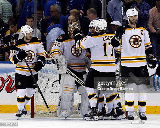 Milan Lucic of the Boston Bruins celebrates with Tuukka Rask after defeating the New York Rangers in Game Three of the Eastern Conference Semifinals...