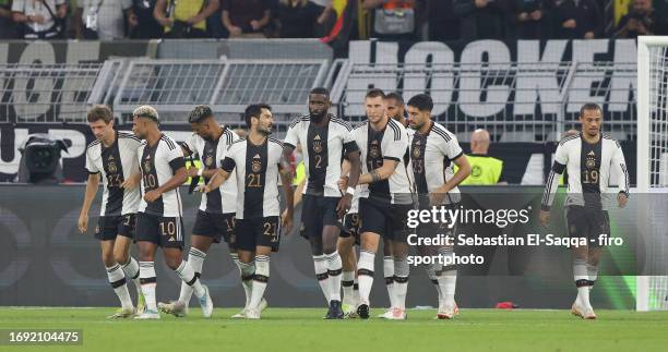 Thomas Müller of Germany celebrates with teammates after scoring his teams first goal during the international friendly match between Germany and...