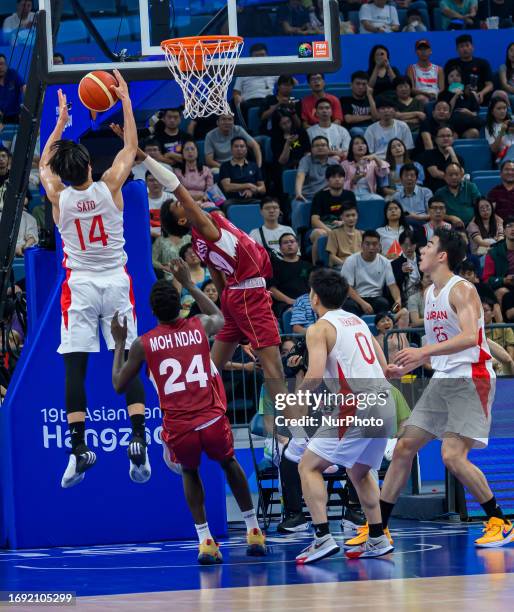 Takuma of Japan in action against MOUSA Abdullah of Qatar in action during the Men's Basketball Preliminary Round Group D match between Japan and...