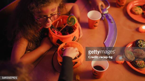 group of children gathering for house halloween party and counting candies that they collected - cute kids stock pictures, royalty-free photos & images