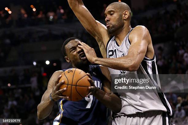 Tony Allen of the Memphis Grizzlies draws contact as he drives against Tim Duncan of the San Antonio Spurs during Game Two of the Western Conference...