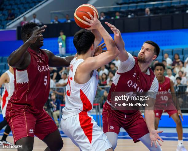 Yuto of Japan in action against ADVIC Faris of Qatar in action during the Men's Basketball Preliminary Round Group D match between Japan and Qatar at...