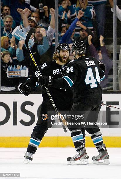 Brent Burns and Marc-Edouard Vlasic of the San Jose Sharks celebrate after Burns scored a goal against the Los Angeles Kings in the first period in...