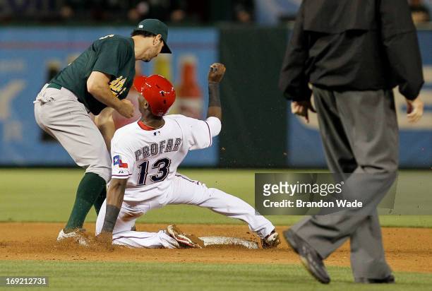 Adam Rosales of the Oakland Athletics tags out Jurickson Profar of the Texas Rangers on an attempted steal during the sixth inning of a baseball game...