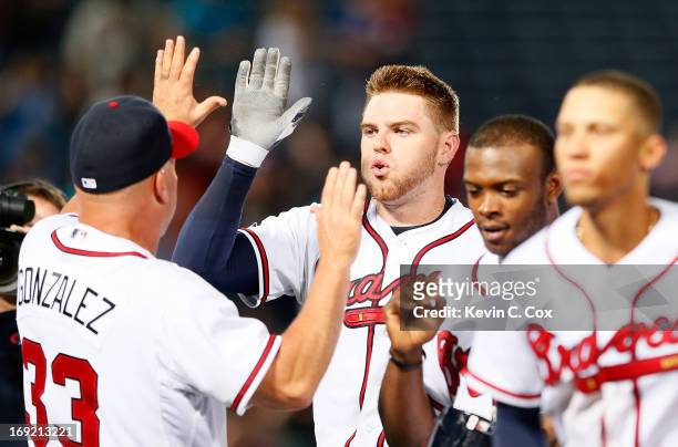 Freddie Freeman of the Atlanta Braves celebrates with manager Fredi Gonzalez after hitting a game-winning RBI single in the bottom of the 10th inning...