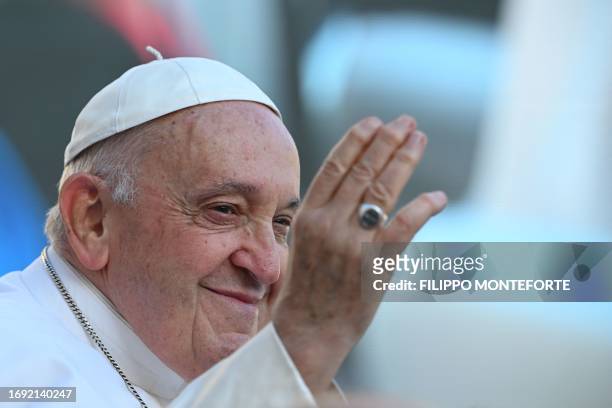 Pope Francis greets the crowd as he arrives for the weekly general audience on September 27, 2023 at St Peter's square in The Vatican.