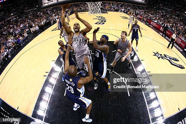 Tim Duncan of the San Antonio Spurs attempts a shot in the second half against Quincy Pondexter and Zach Randolph of the Memphis Grizzlies during...