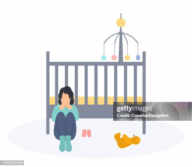 crying mother sitting in front of empty crib. baby booties and teddy bear on the floor. baby loss, miscarriage, grieving parent and postnatal depression concept - premature stock illustrations