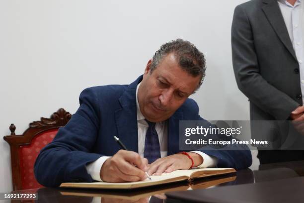 The president of the Provincial Council, Javier Fernandez, signs in the book of honor during the visit to the mantecados la Estepeña factory, on...