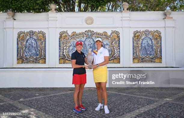 Stacy Lewis, captain of team USA and Suzann Pettersen, captain of team Europe pose with the Solheim Cup trophy during the official photocall prior to...
