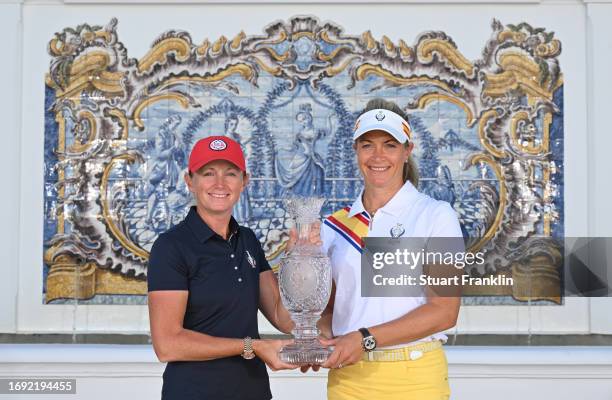 Stacy Lewis, captain of team USA and Suzann Pettersen, captain of team Europe pose with the Solheim Cup trophy during the official photocall prior to...