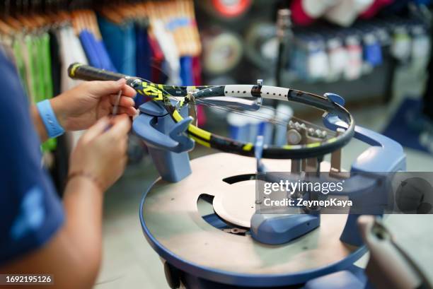 stringing the tennis racket on stringer - exercise equipment store stock pictures, royalty-free photos & images