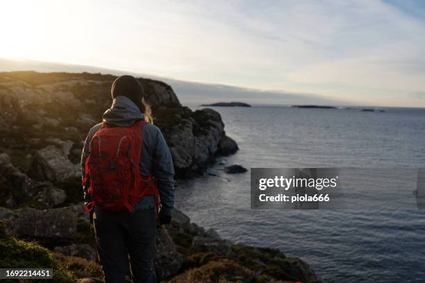 woman hiking outdoors in norway, by a fjord - bergen stock pictures, royalty-free photos & images