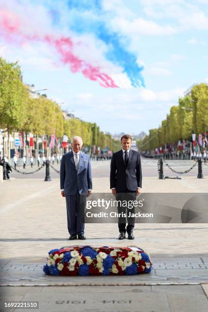 King Charles III and President of France, Emmanuel Macron stand in front of the Tomb of the Unknown Soldier. The Franco-British Wreath decorated with...