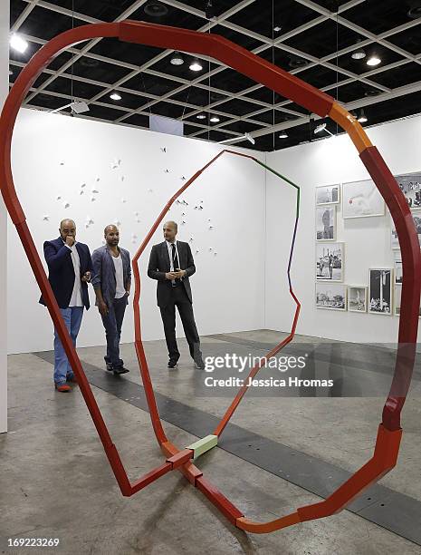 Buyers look at work from Max Wigram Gallery, London, at Art Basel, May 22, 2013 in Hong Kong.