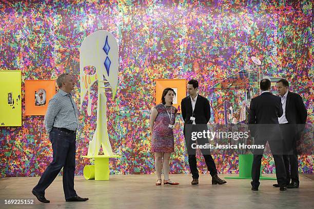 People mingle by the Michael Werner, New York, London, gallery space at Art Basel , May 22, 2013 in Hong Kong.