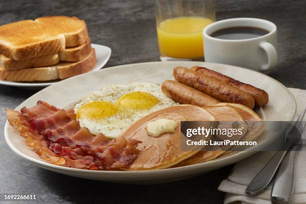 grand slam breakfast with pancakes, bacon, eggs, and toast - grand slam breakfast stock pictures, royalty-free photos & images