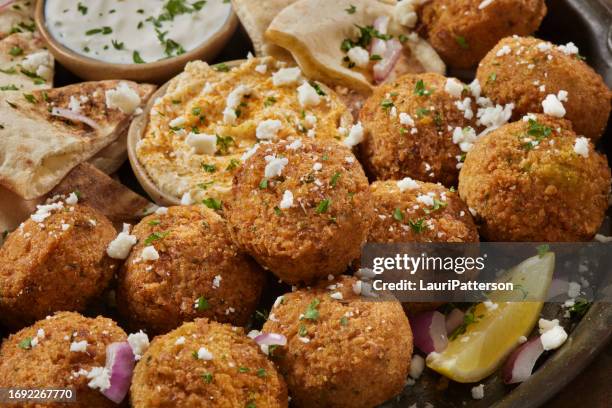 falafel platter with tzatziki sauce - greek food spread stock pictures, royalty-free photos & images